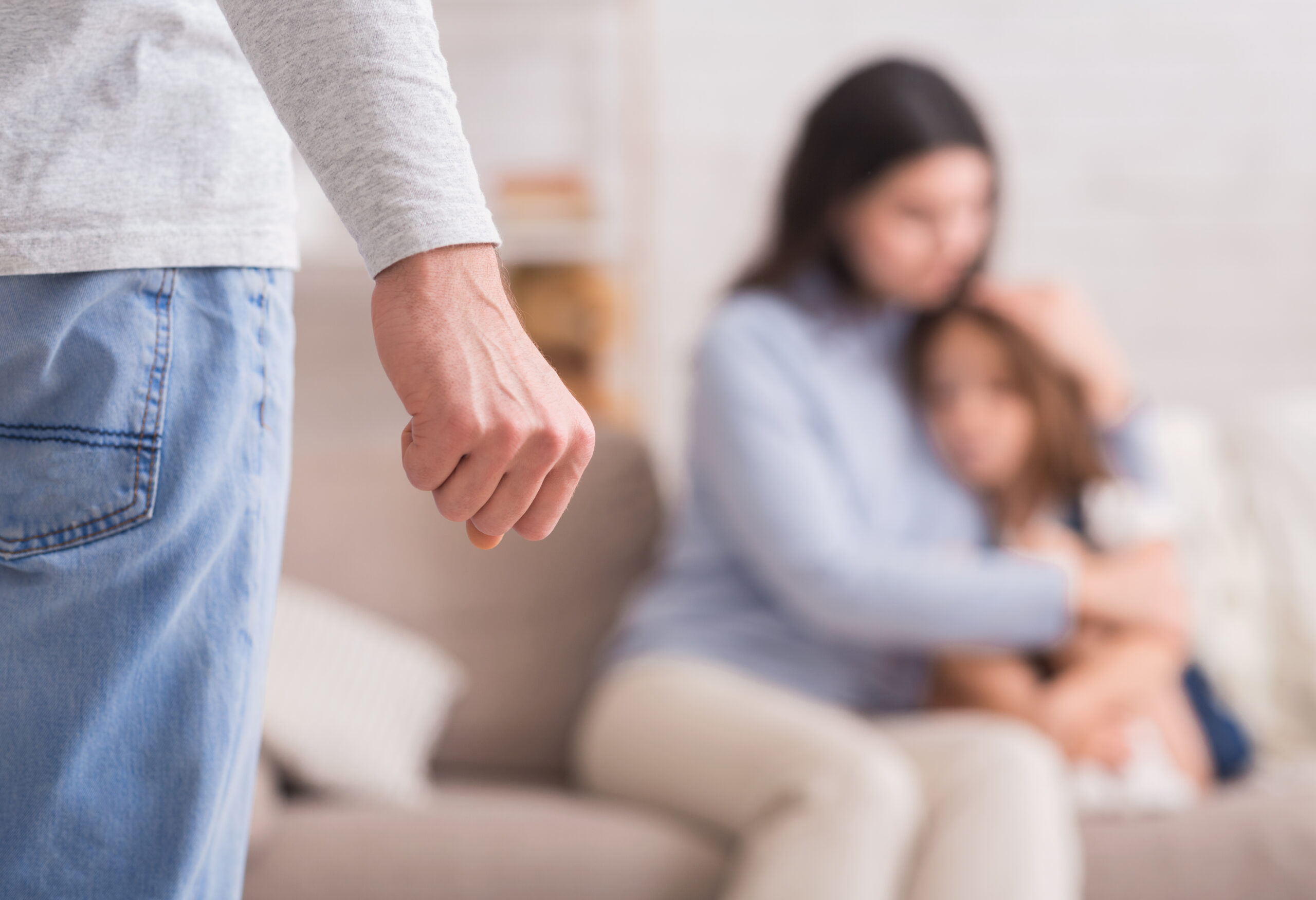 man with fist infront of family
